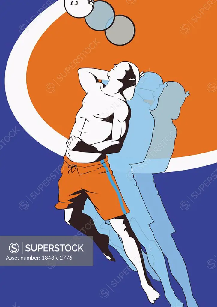 Young man reaching to hit volleyball