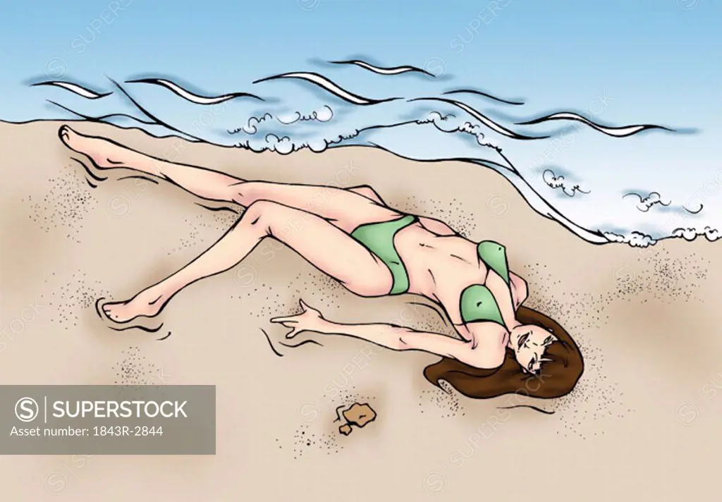 Woman lying by the water on the beach