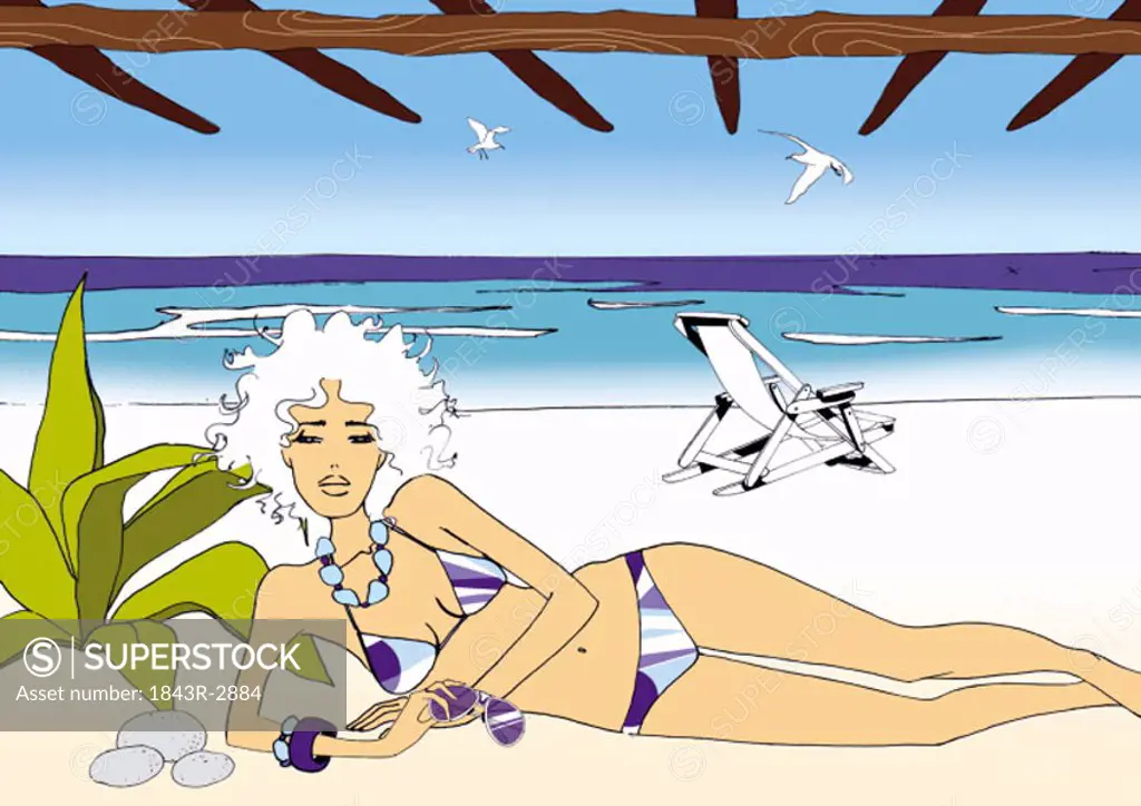 Woman in bikini lying on the beach under a pergola