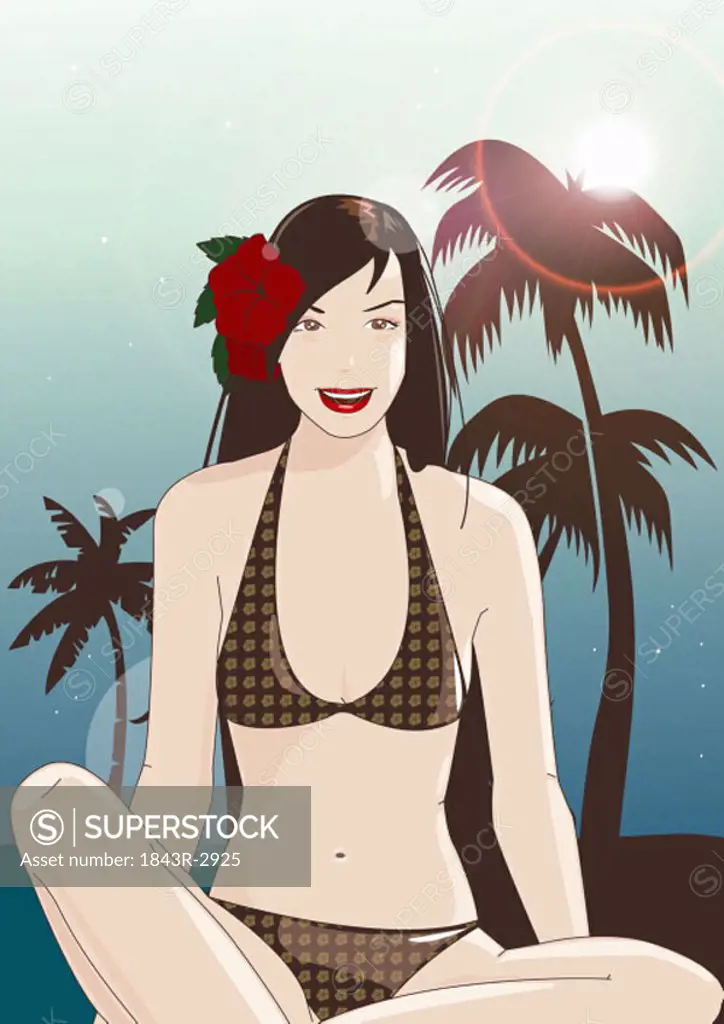 Young woman in bikini with flower in her hair