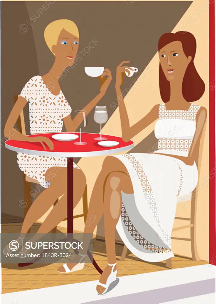 Two women sitting at a cafe table