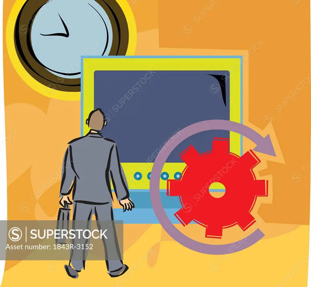 Rear view of a man by a big computer screen and clock