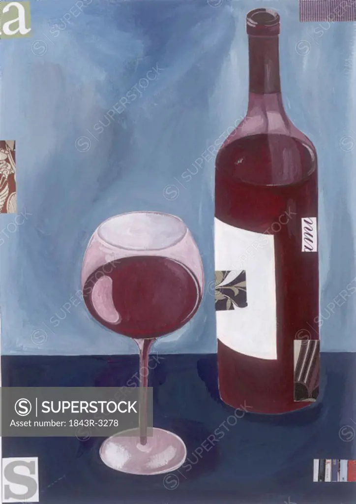 A glass of red wine with a bottle