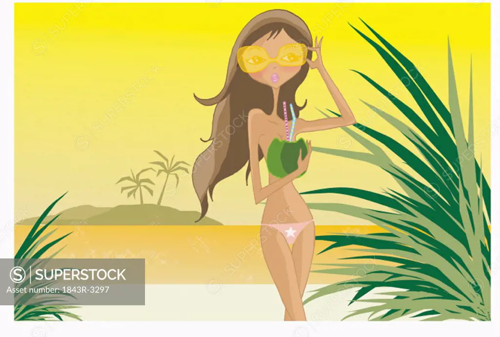 Woman in shades with fruit drink on the beach