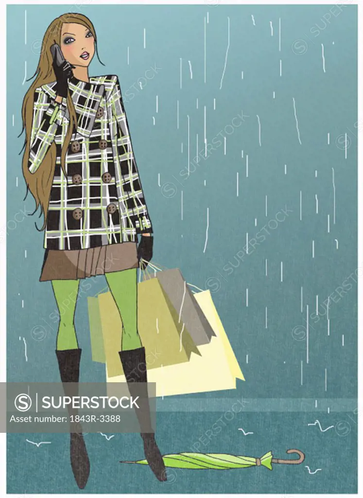 Woman caught in the rain with her shopping bags talking on the mobile phone