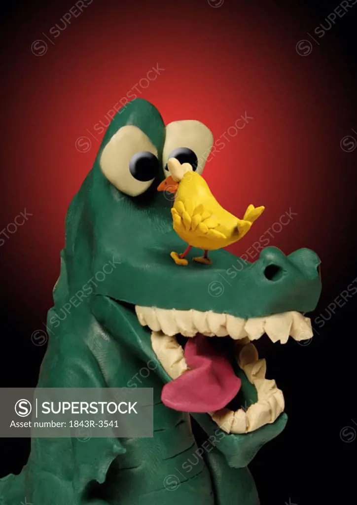 Alligator with bird on his snout