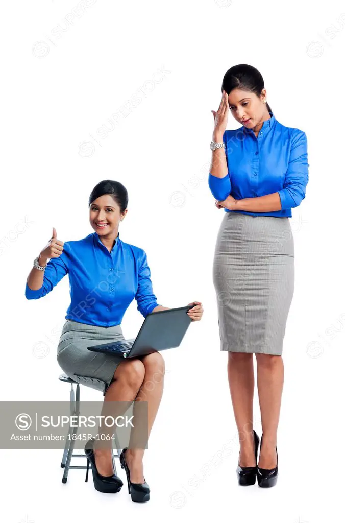 Businesswoman celebrating her success with her clone standing beside her
