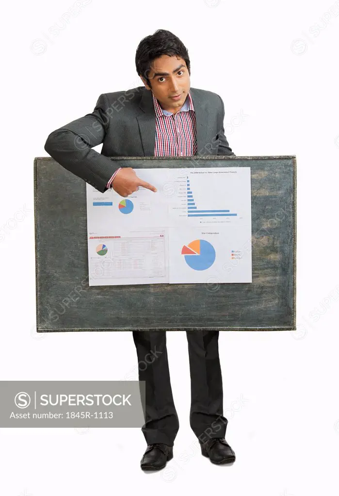 Portrait of a businessman pointing at a chart