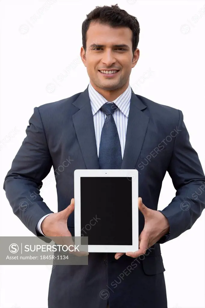 Portrait of a smiling businessman holding a digital tablet