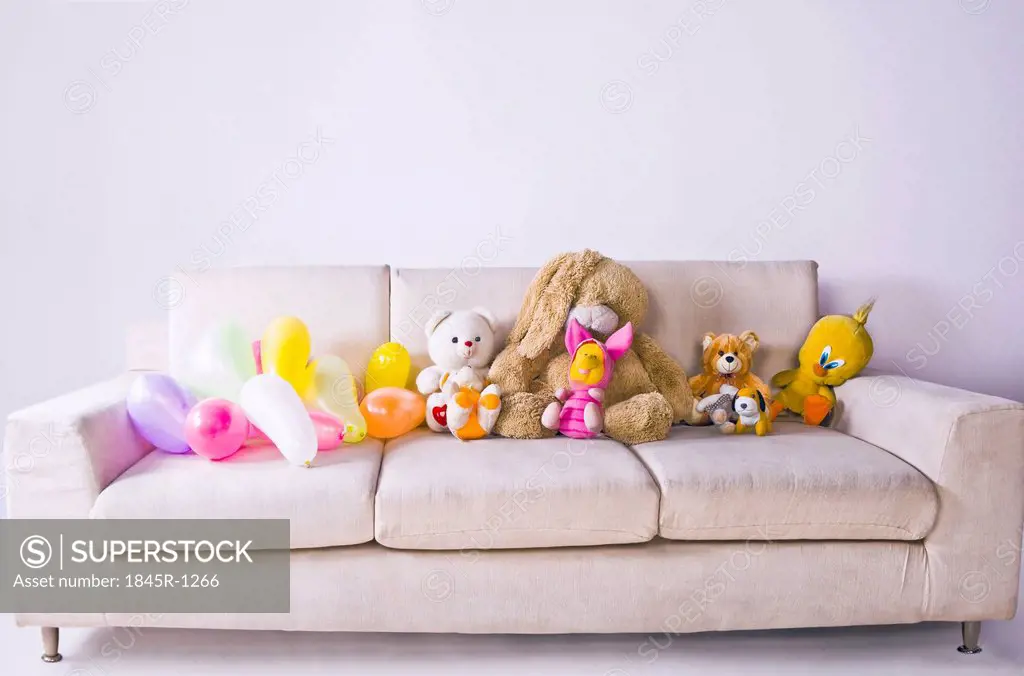 Soft toys and balloons on the couch
