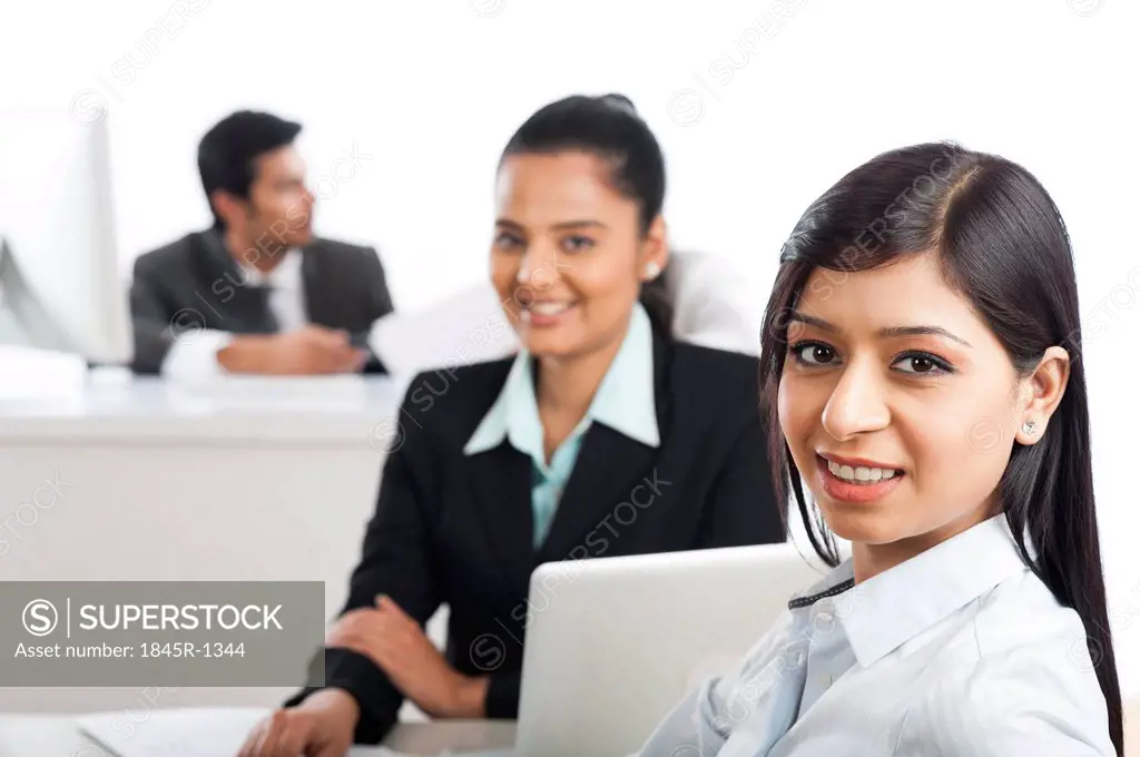 Portrait of two businesswomen smiling in an office
