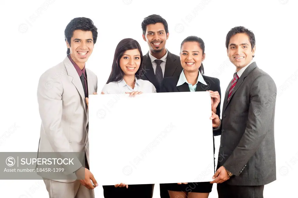 Portrait of business executives holding a placard and smiling