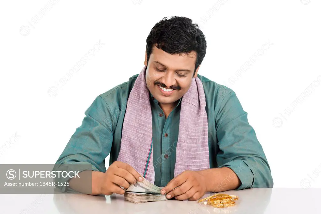 Smiling man counting money