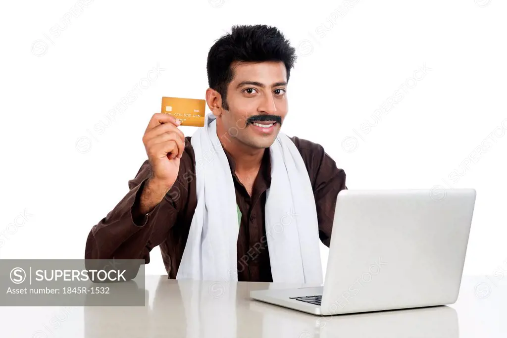 Portrait of a man doing online shopping with a credit card
