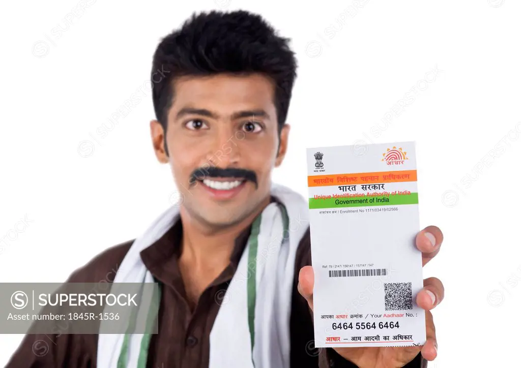 Portrait of a man showing Aadhar Card