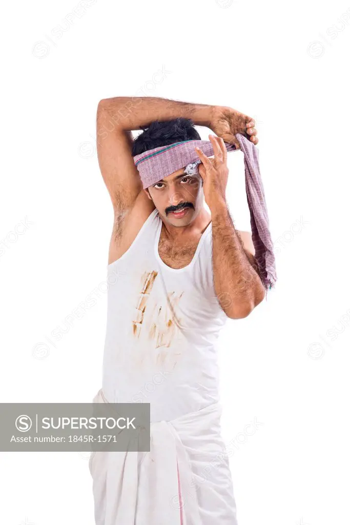 Portrait of a farmer wrapping cloth on his head