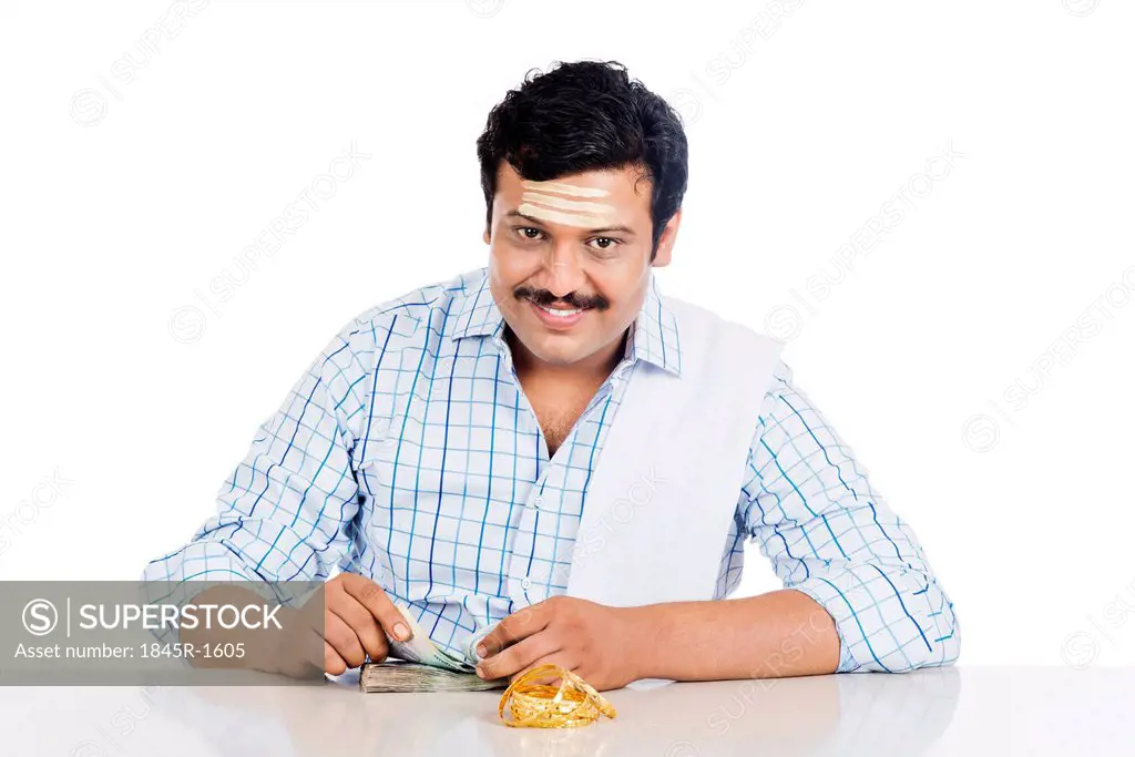 Portrait of a South Indian man counting money