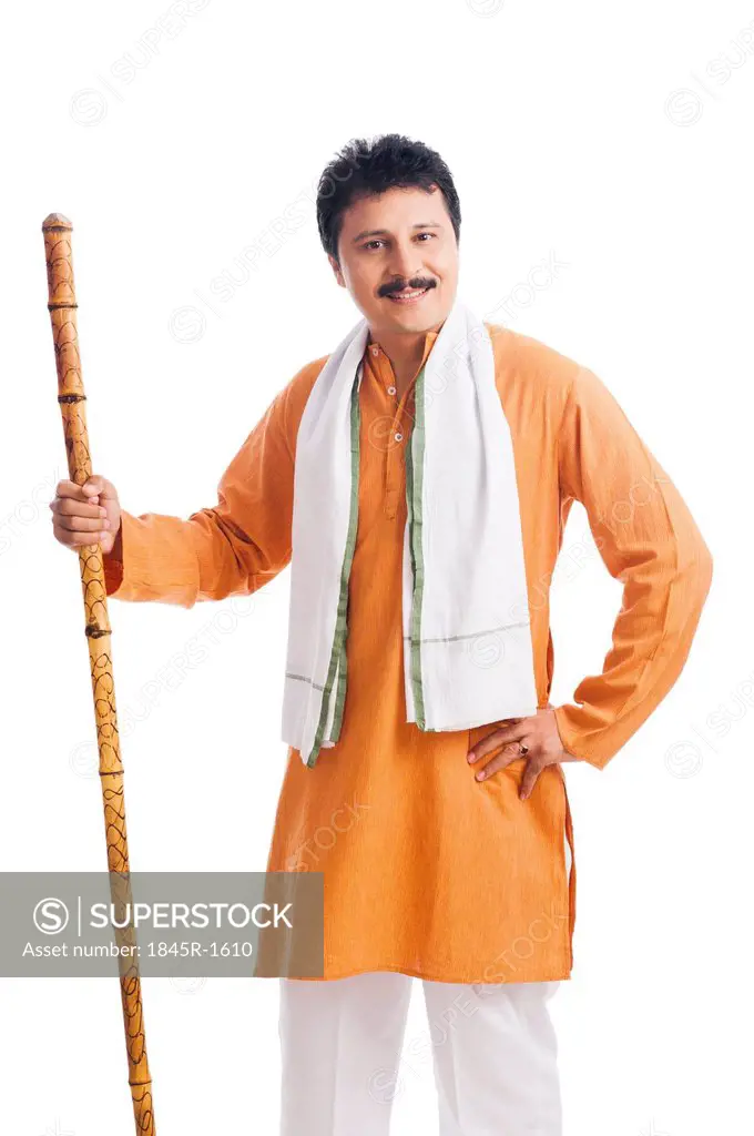 Portrait of a man holding wooden staff and smiling