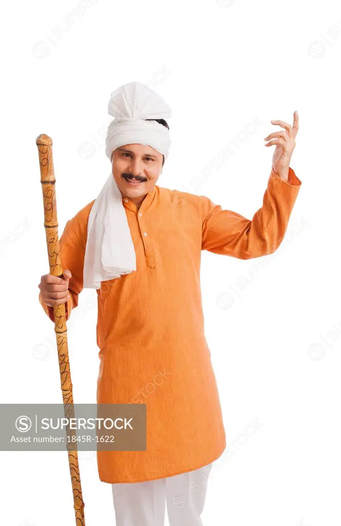 Portrait of a man holding wooden staff and gesturing