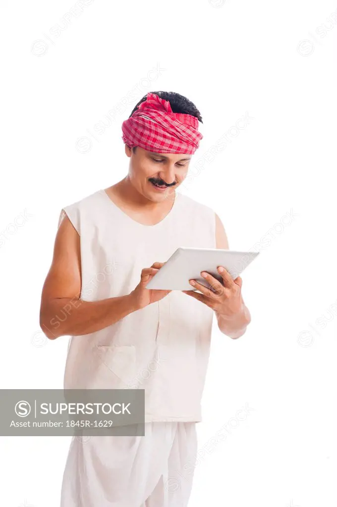 Farmer using a digital tablet and smiling