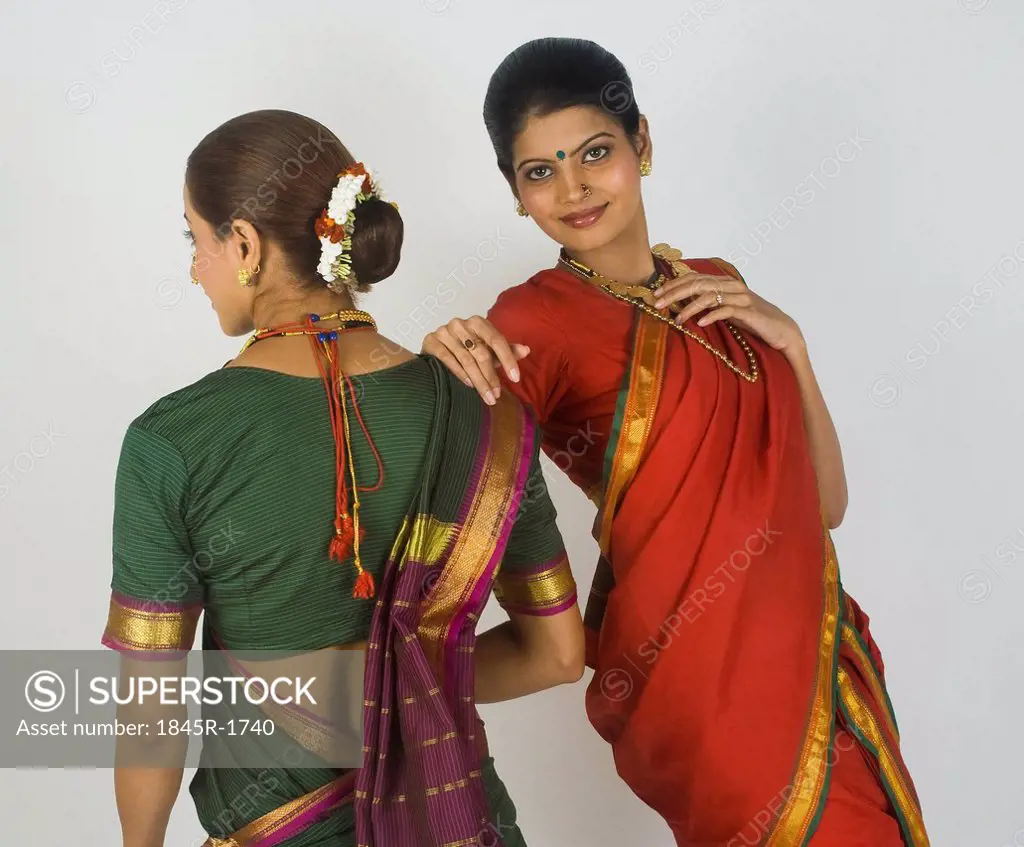 Two female folk dancers standing together in traditional Maharashtrian dress