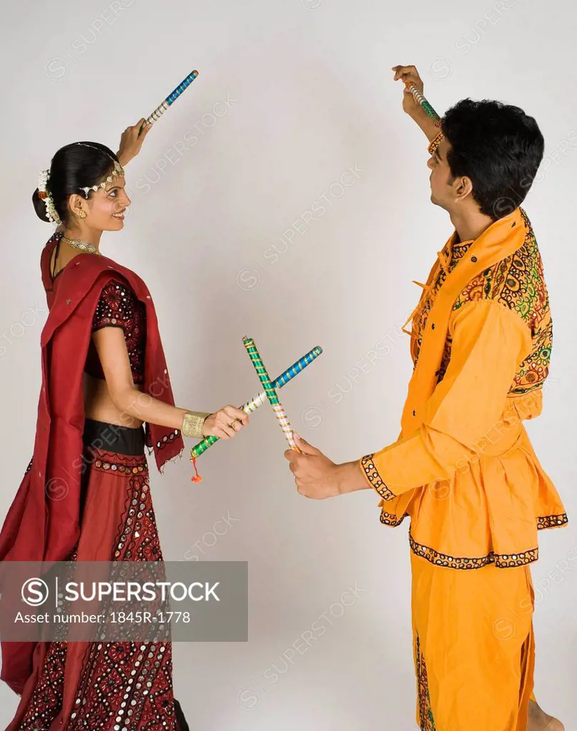Couple performing dandiya