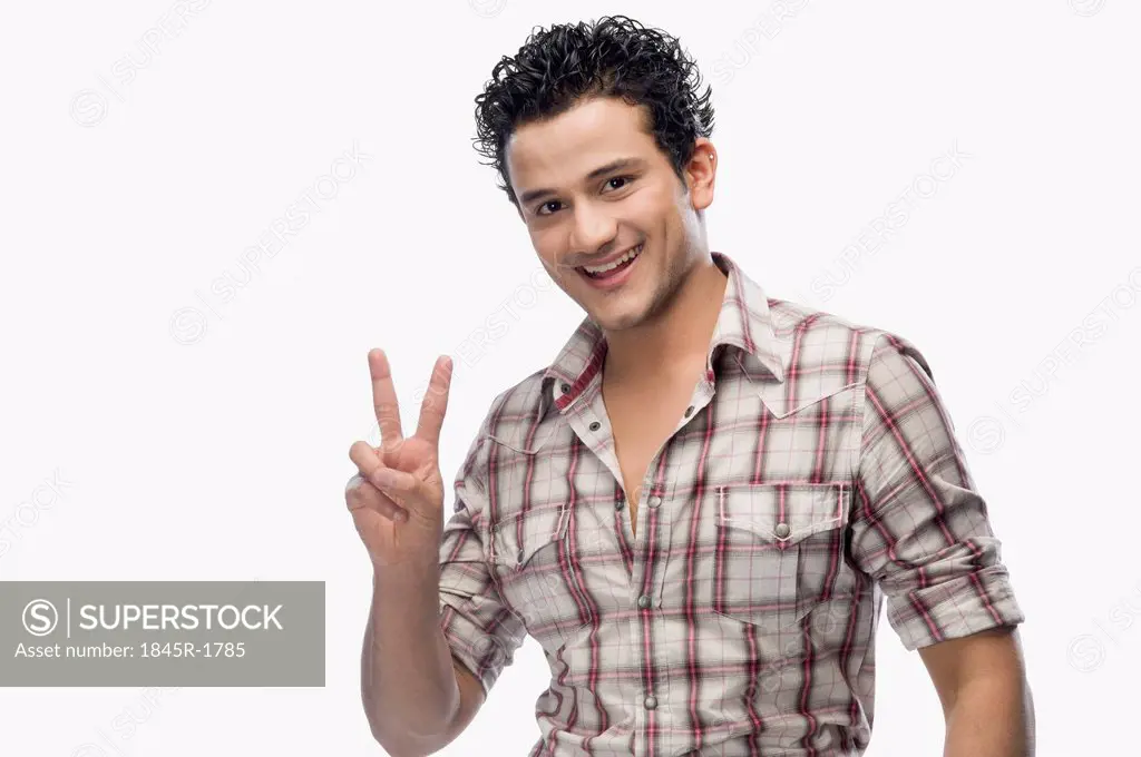Portrait of a man showing victory sign