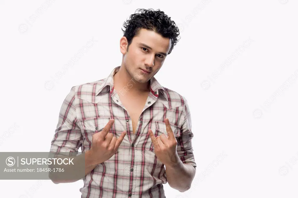 Portrait of a man gesturing 'Rock and Roll' sign