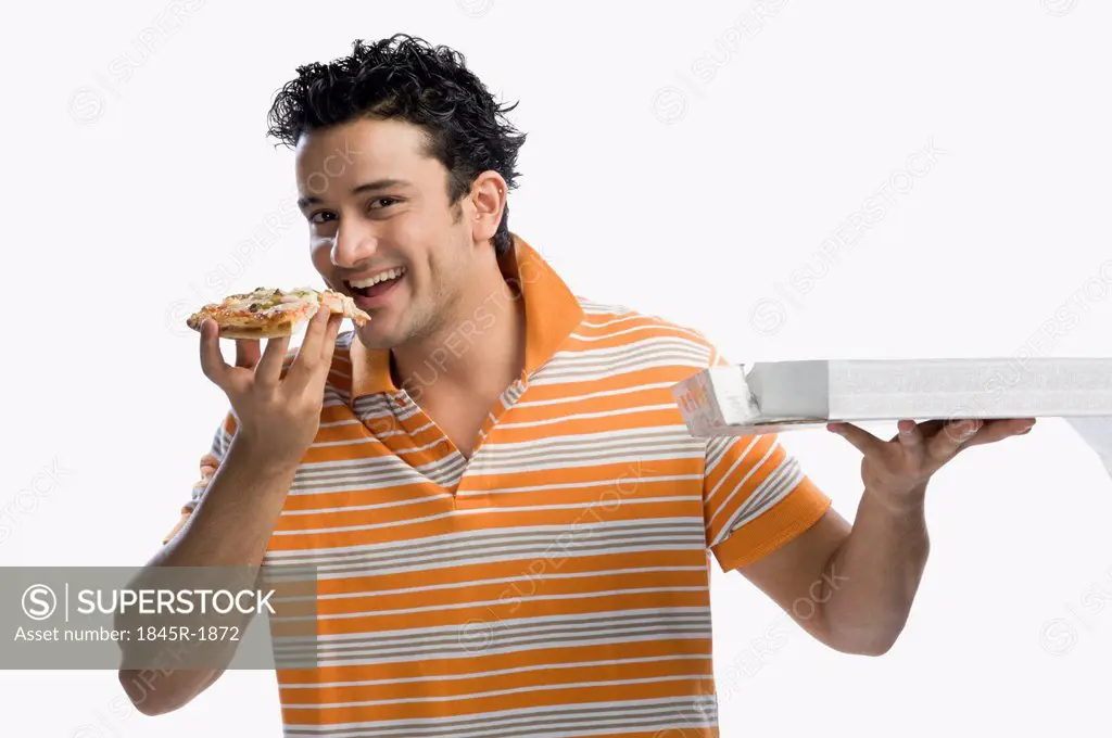 Portrait of a man eating pizza and smiling