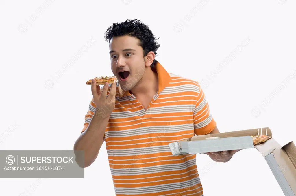 Close-up of a man eating pizza