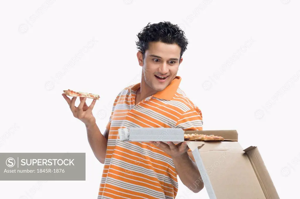 Close-up of a man looking at pizza