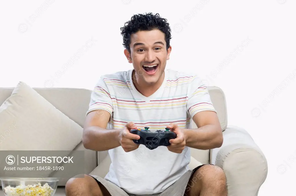 Man playing a video game and looking excited