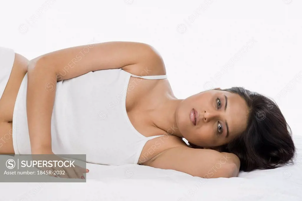 Portrait of a woman lying on the bed