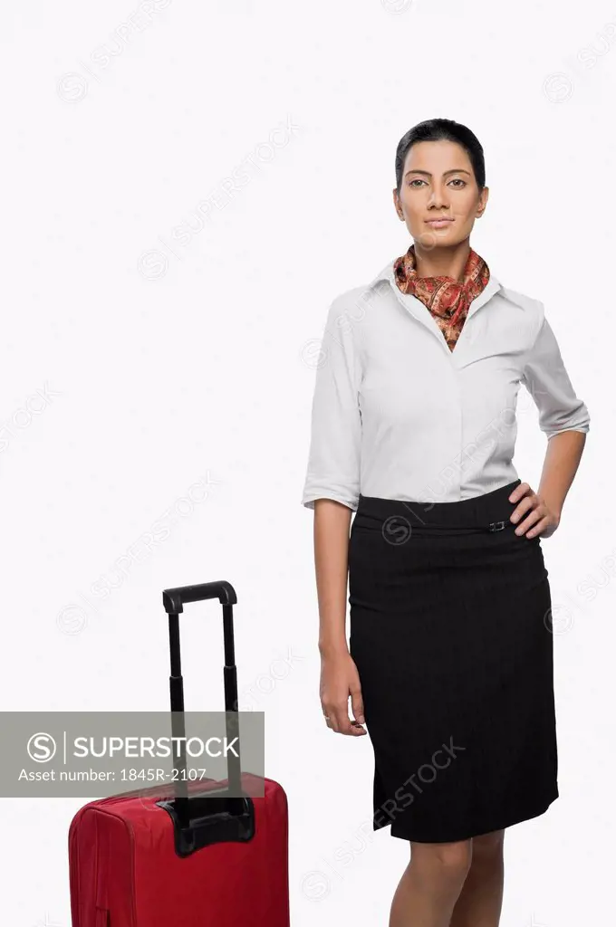 Portrait of an air hostess with her luggage