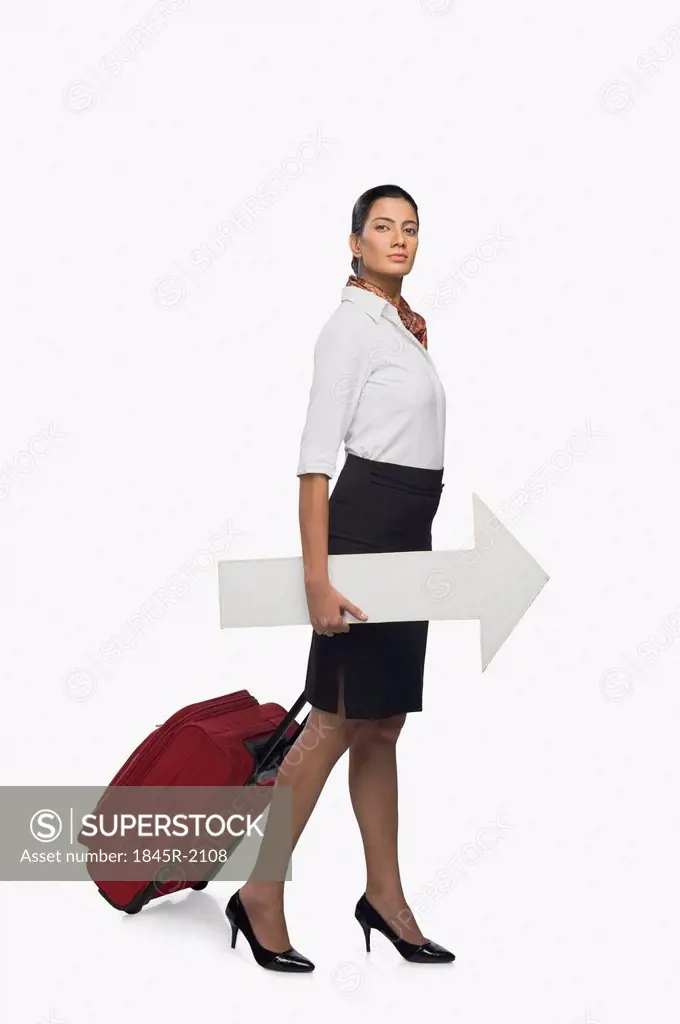 Air hostess carrying luggage with an arrow sign