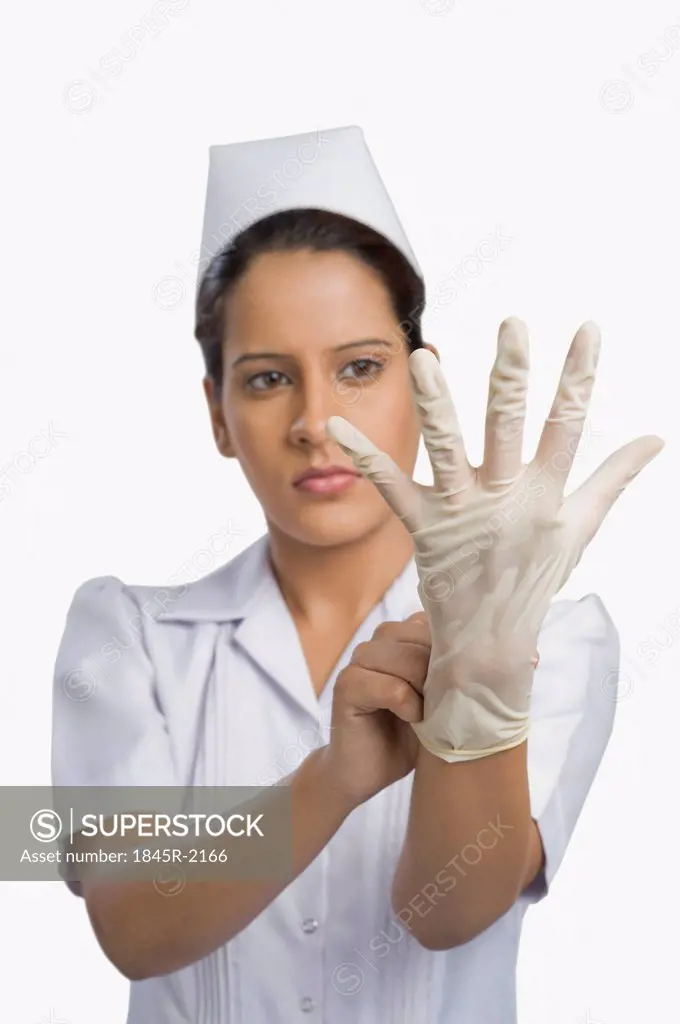 Female nurse wearing a surgical glove