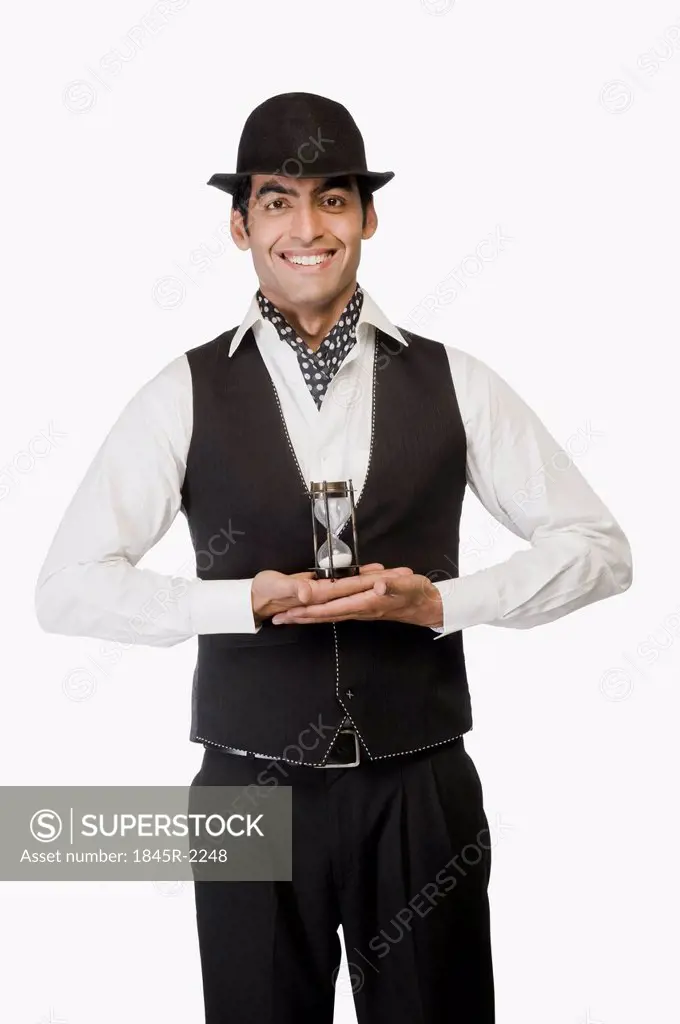Portrait of a businessman holding an hourglass