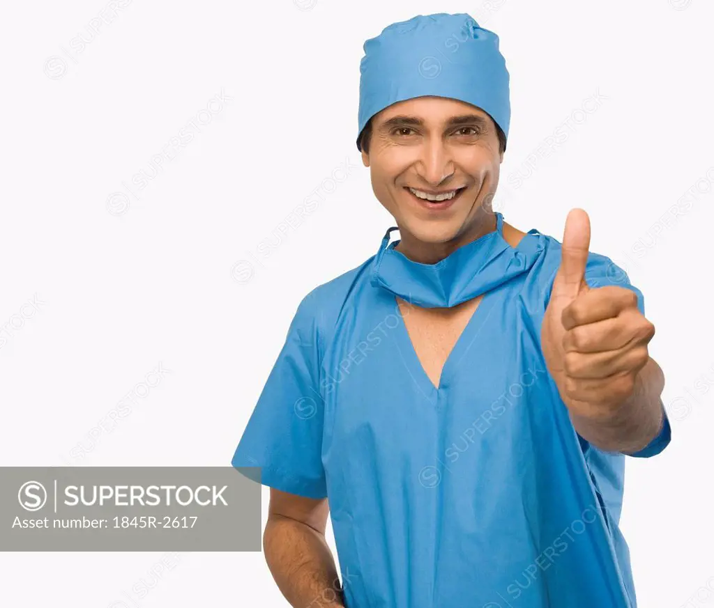 Portrait of a surgeon showing thumbs up and smiling