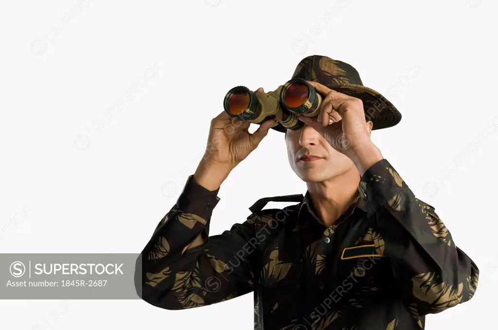 Army soldier looking through binoculars