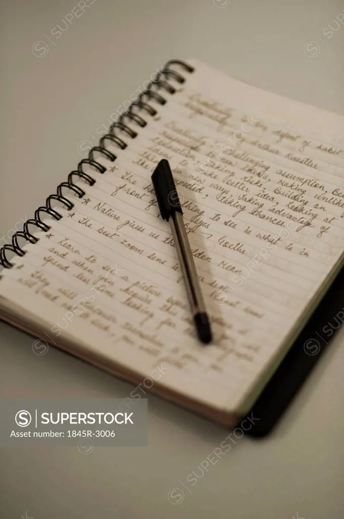 Close-up of a pen on an open notebook