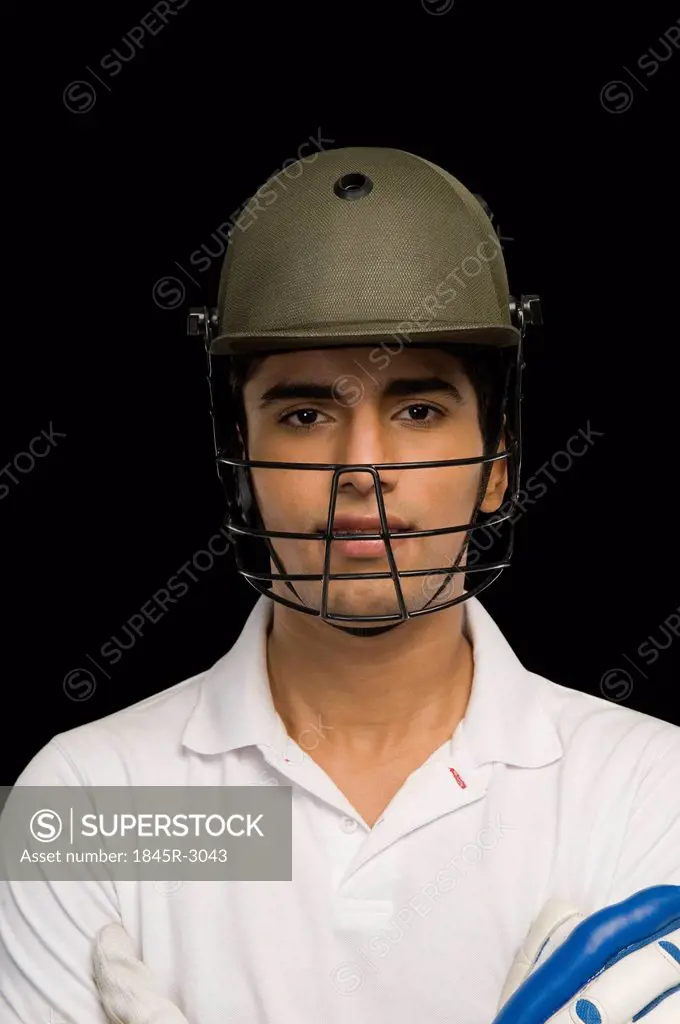 Portrait of a cricket batsman wearing a cricket helmet
