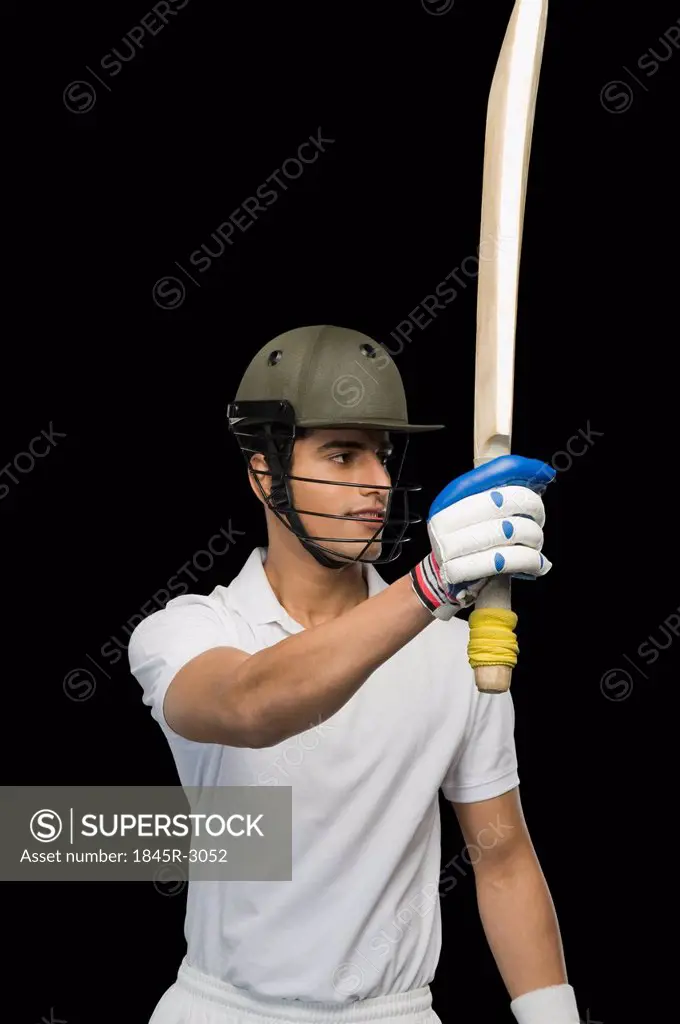 Cricket batsman raising his bat