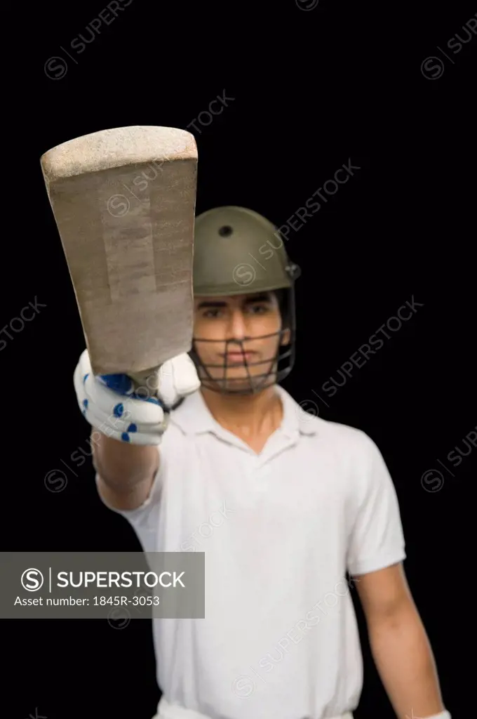 Cricket batsman raising his bat