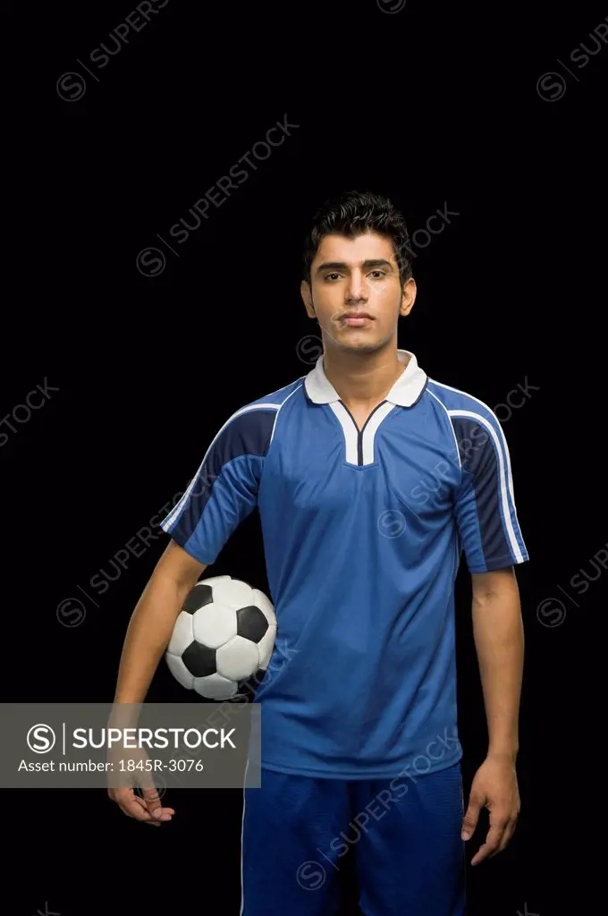 Soccer player holding a soccer ball