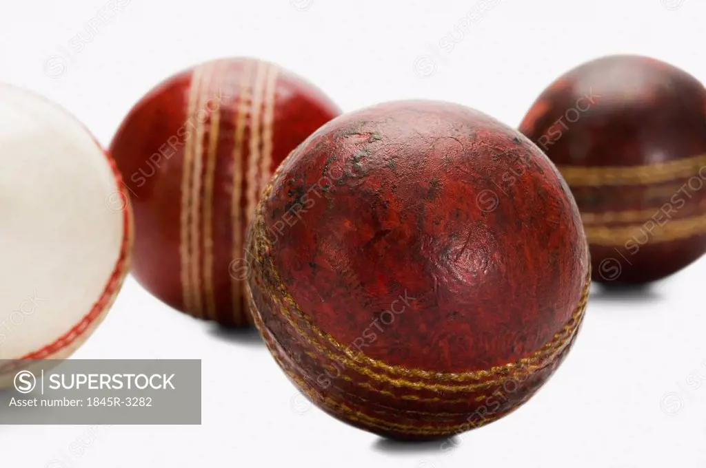 Close-up of old and new cricket balls
