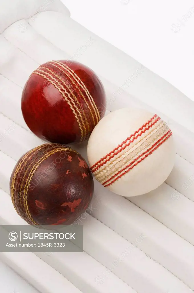 Close-up of cricket balls on cricket pads