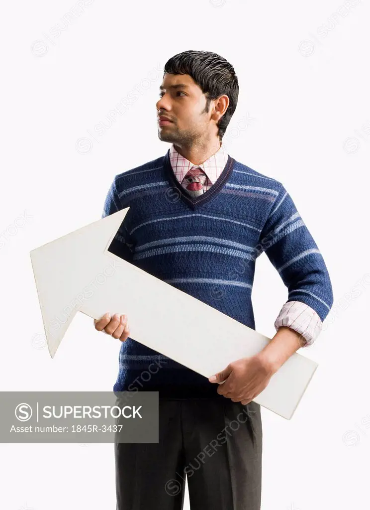 Businessman holding an arrow sign