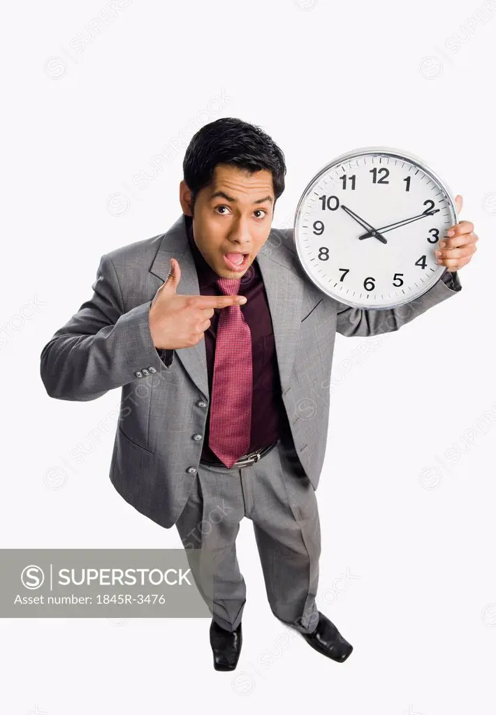 Businessman showing a clock