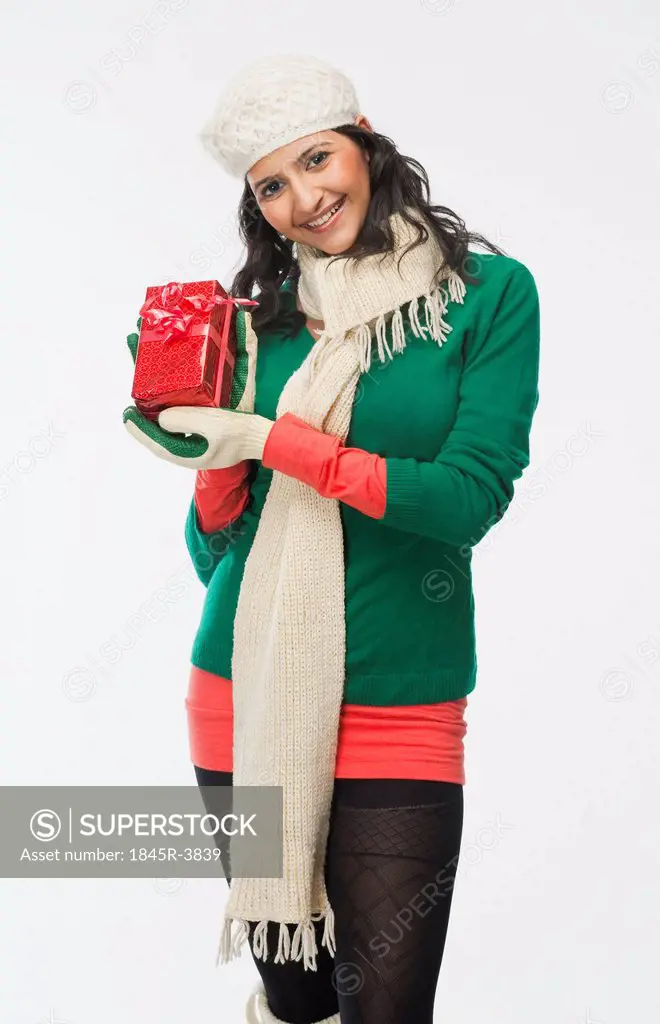 Woman holding a gift box and smiling