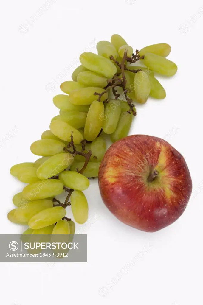 Close-up of a bunch of grapes with an apple